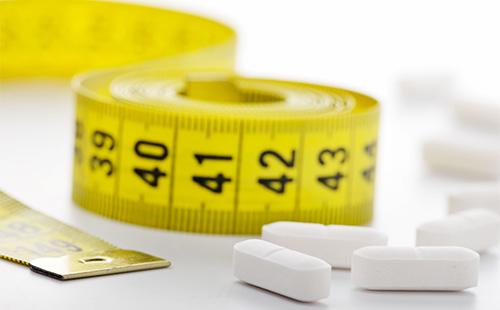 Pills and white centimeter