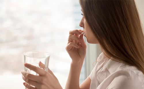 Woman taking medicine