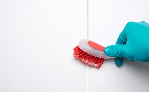 Brushing a tile in a bathroom