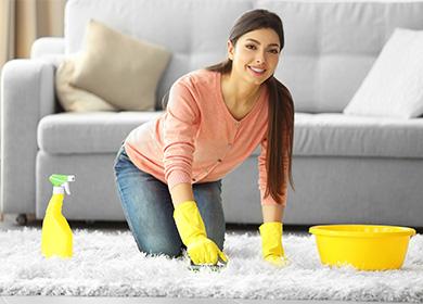 Woman washes a carpet