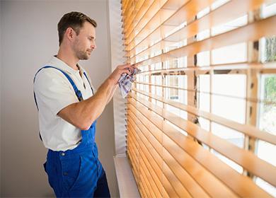 Man wipes the blinds