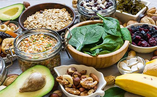 Spinach, nuts, avocado in bowls