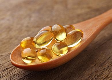 Fish oil capsules in a spoon