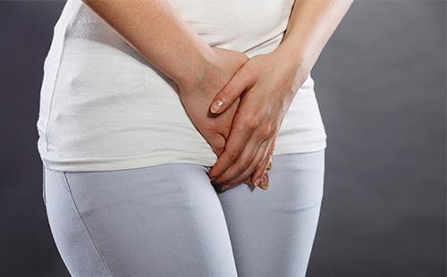 Female hands in the lower abdomen