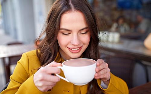 Happy girl with a cup of cocoa