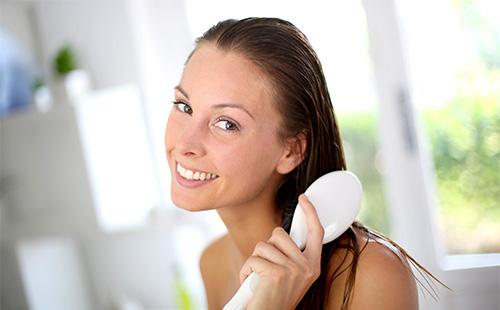 Beautiful girl combing her hair