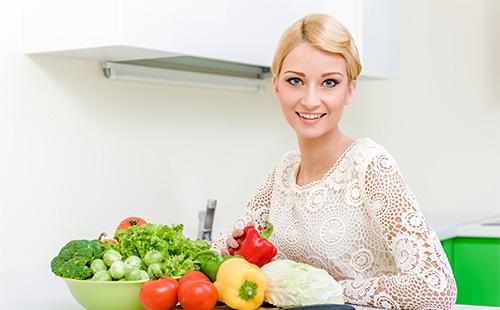 Girl and vegetables on the table