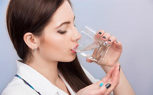Woman drinking a pill