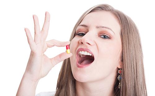 Girl about to take a pill