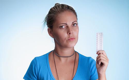 A girl in a blue T-shirt is holding a tablet