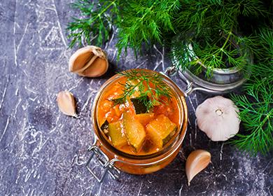 Canned vegetables in a jar with garlic and branches of spruce