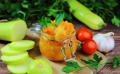 Canned vegetables in a jar, sliced zucchini, cherry tomatoes and parsley