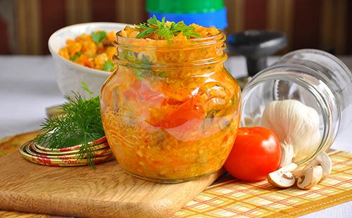 Canned vegetables in a jar with tomatoes and herbs