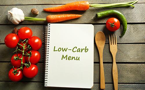 Notebook with menu and vegetables for cooking.