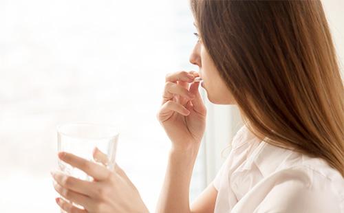 Woman taking medicine