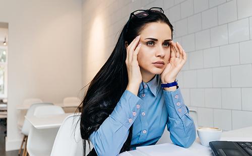 The woman has a headache