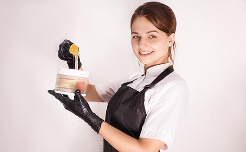 Beautician with syrup for shugaring