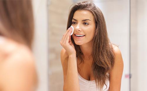 Young girl cleanses her face