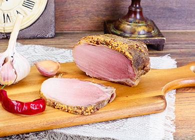 A piece of boiled pork, a head of garlic and a pod of pepper