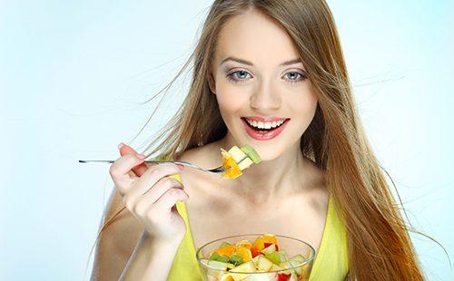 Girl eating fruit salad