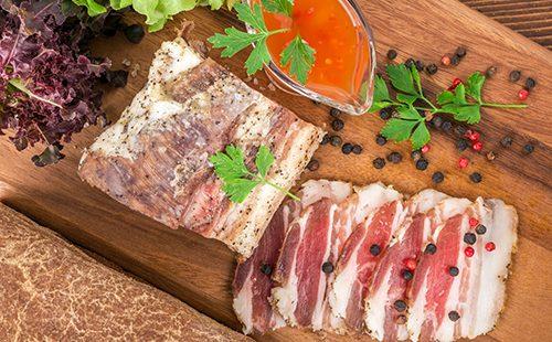 Lard with herbs on a cutting board