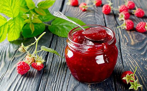 Raspberry jam in a jar on the table