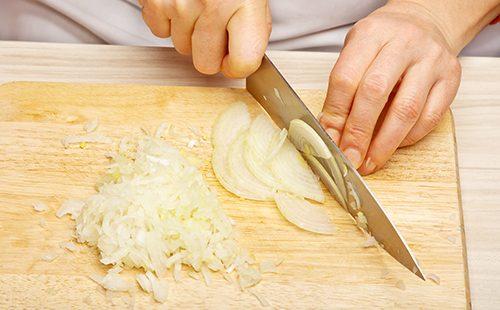 Woman cuts onions