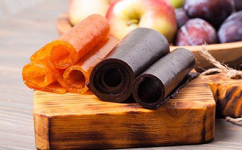 Apples, plums and marshmallows on the board