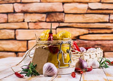 Yellow squash in a jar among garlic