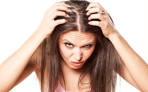 Woman examines her head