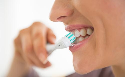 Woman brushing teeth