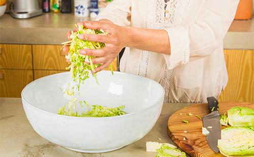 Woman slices cabbage