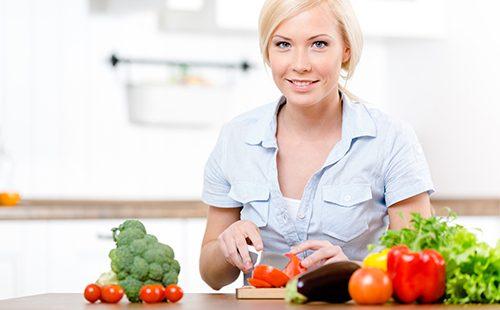 Woman cuts vegetables