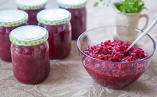 Beetroot salad in bowl and jars