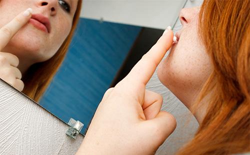 Woman smears lips with cream