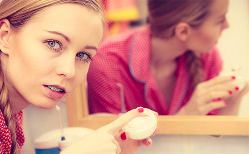 Girl smears face cream