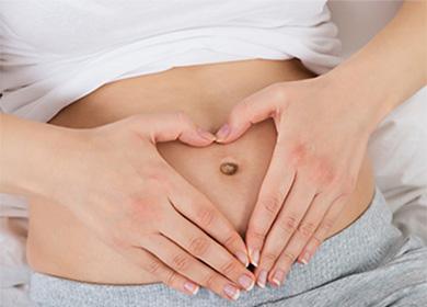 Heart made of fingers on the stomach