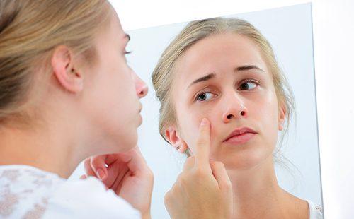 Teenage girl with a mirror