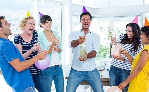 Guy opens a bottle of champagne