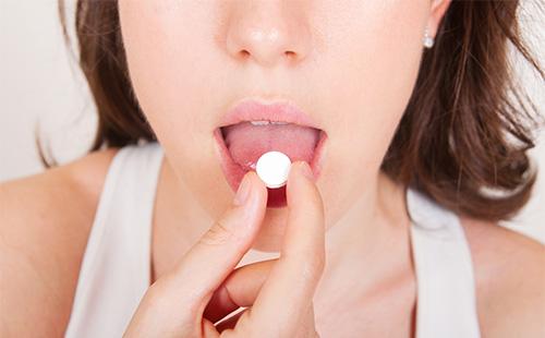 Woman taking medicine