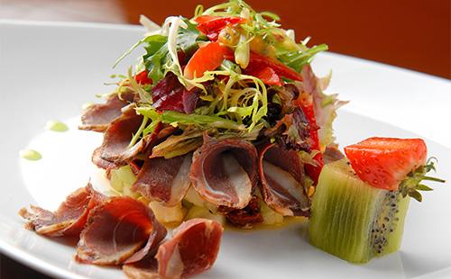 Smoked sausage salad on a plate