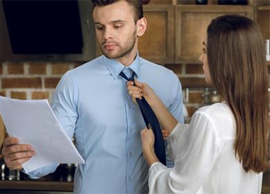 A woman ties a tie to her husband