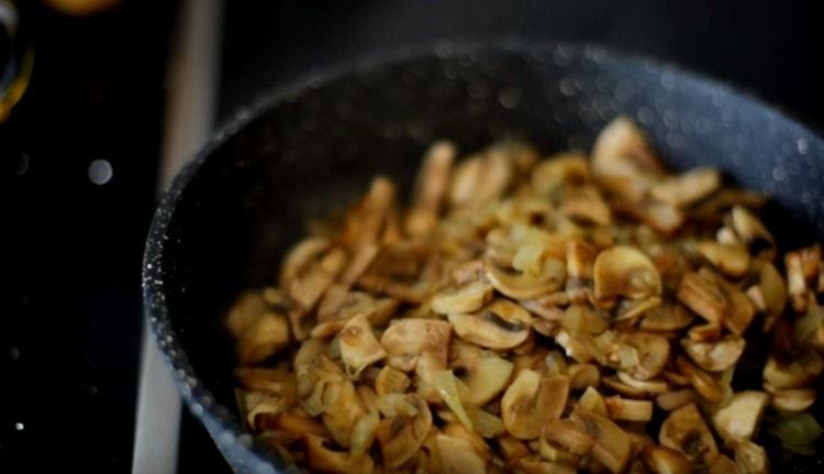 Fry mushrooms with onions in a pan until cooked.