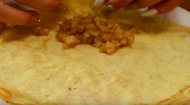Wrap our pancakes with apples and cinnamon, forming envelopes.