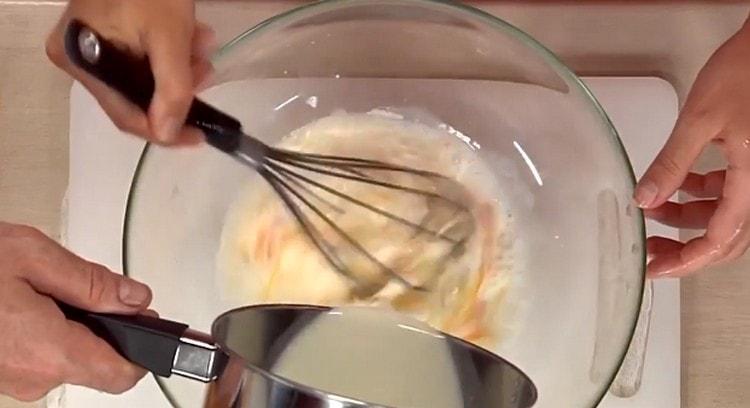 Beat the eggs and introduce milk into them.