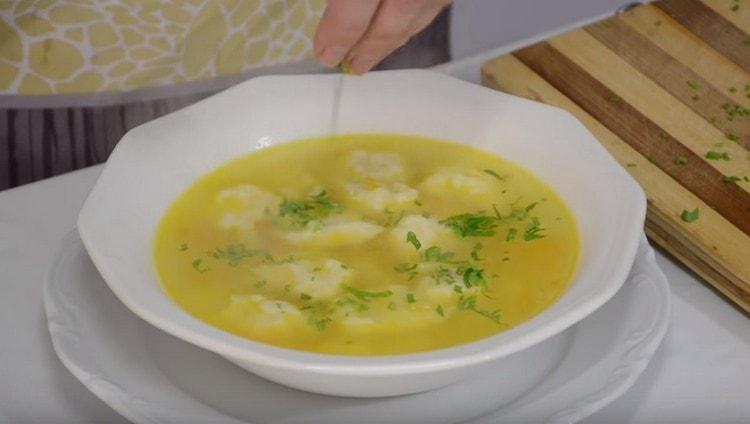 Fragrant chicken soup with dumplings can be sprinkled with herbs when serving.