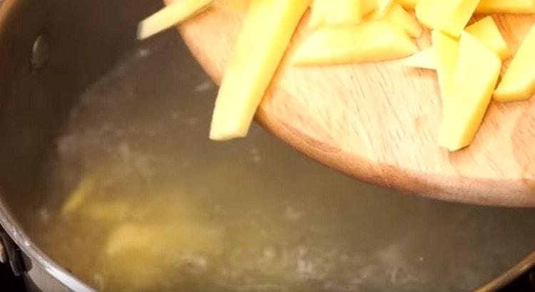 We put chopped potatoes into the broth.