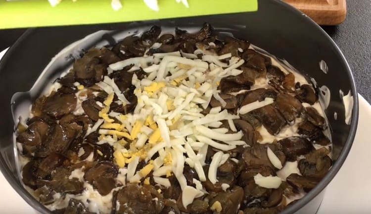 Rub the boiled chicken eggs over the mushroom layer.