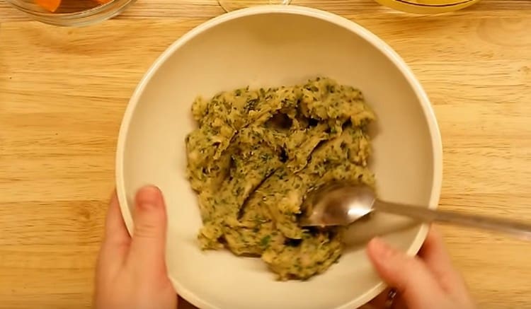 meat is passed through a meat grinder and mixed with chopped herbs.