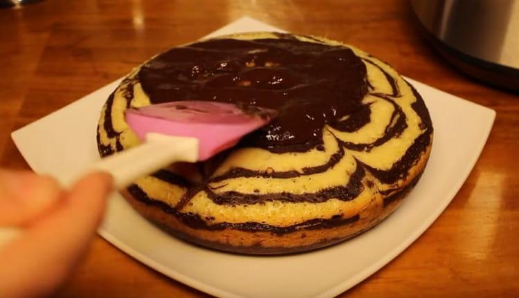 Water our cake with icing.